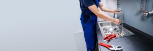 plumber-fixing-sink-faucet-scaled